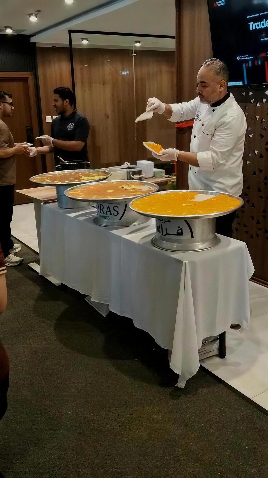 The chef serving kunafa to the team