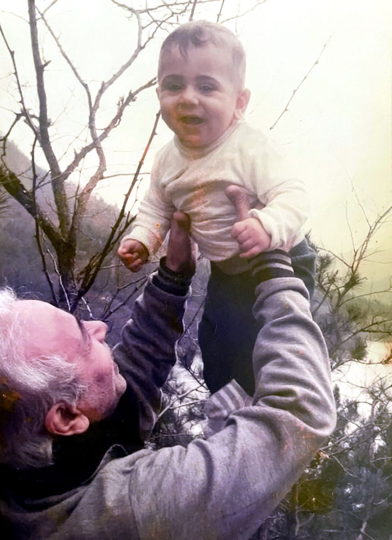Mohammed Mokhles Murad lifting a smiling baby