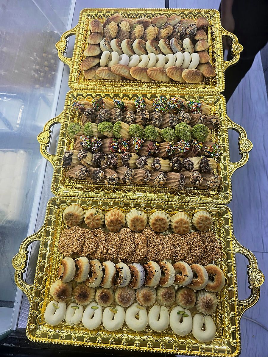 Three gold platters of mixed sweets for an event